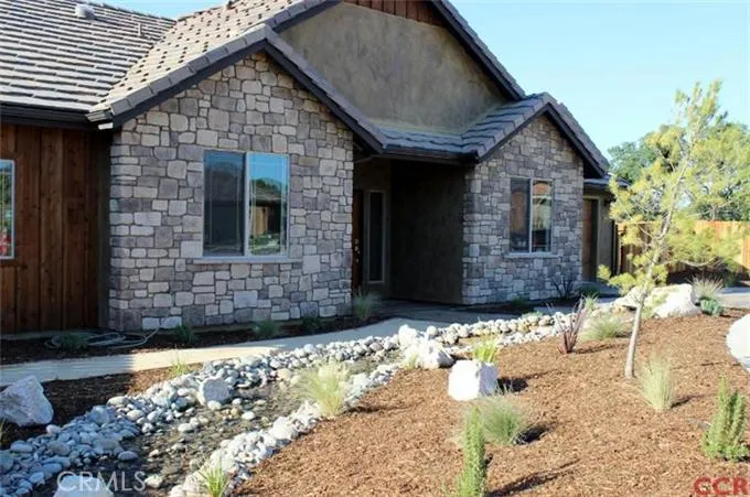Front landscaping with water feature...very attractive home!