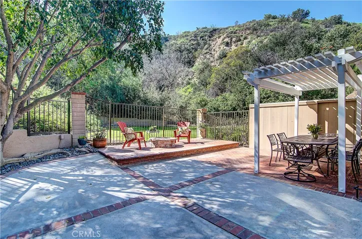 Step Out Back and.. in a word, Be WOWED! Generous Yard with Tasteful Brick Accents, Gas Fire Feature, Covered Dining Area, and the Privacy found almost no where else! You have just one neighbor (to the right in a single story). Otherwise NO ONE in any direction for hundreds of feet... Talk about a DARE to COMPARE moment!