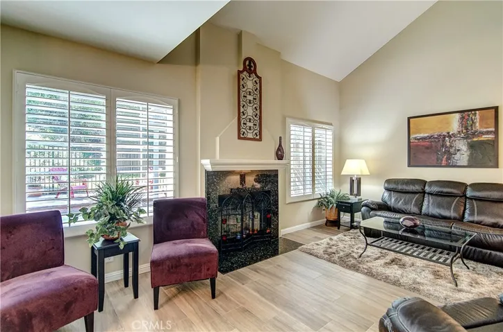 Welcome: High End EVERYTHING awaits... NEW Wood Look Tile Floors, Top Tier Plantation Shutters Throughout, Soaring ceilings, Stone Faced Fireplace, AND.....