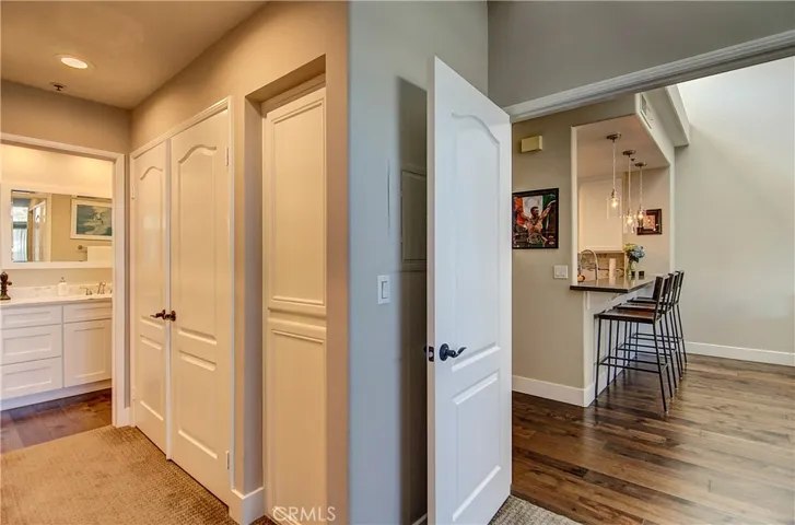 Dressing area with huge closets and linen storage.