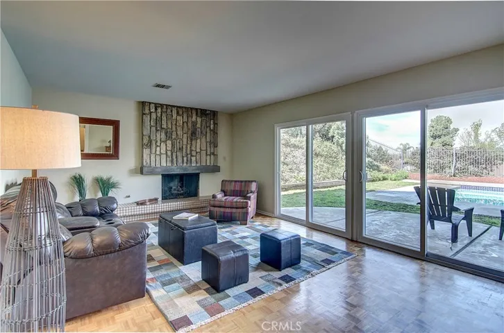 Giant Family Room with fireplace and raised hearth have a mid century vibe, plus seamless indoor/outdoor transitons to huge rear yard and pool.