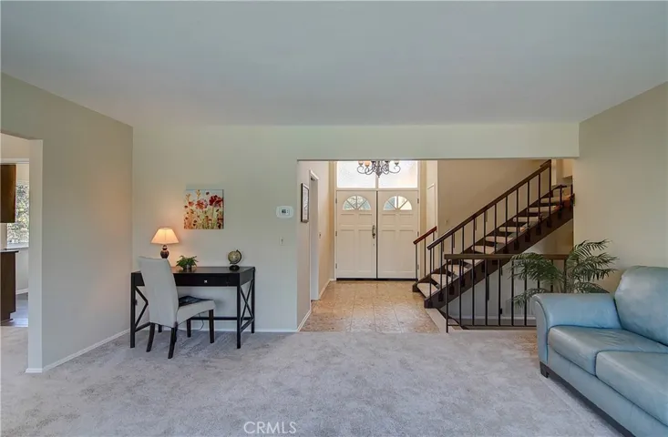 Huge windows above double door entry bathe the spaces in gorgeous sunlight...no skylights necessary in this home!