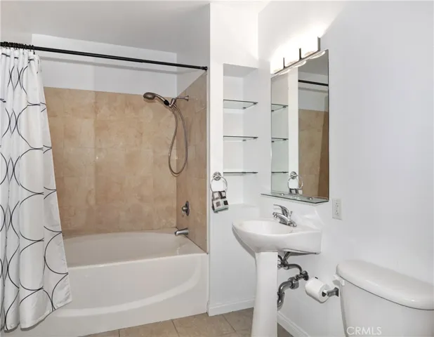 New tile on the bathroom floor, and shower walls creates a luxurious master bath.  The large sunken tub with new faucet and toilet add to the value.