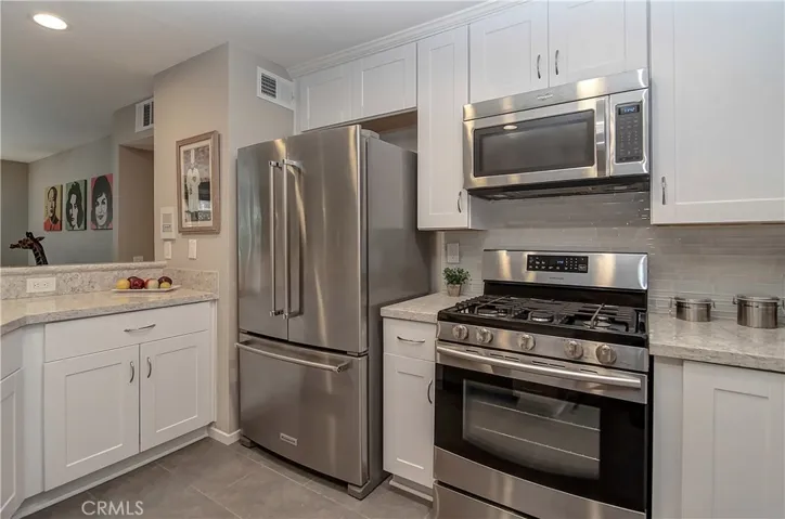 Completely remodeled kitchen with gorgeous modern cabinetry, quartz counters, custom backsplash and stainless appliances.
