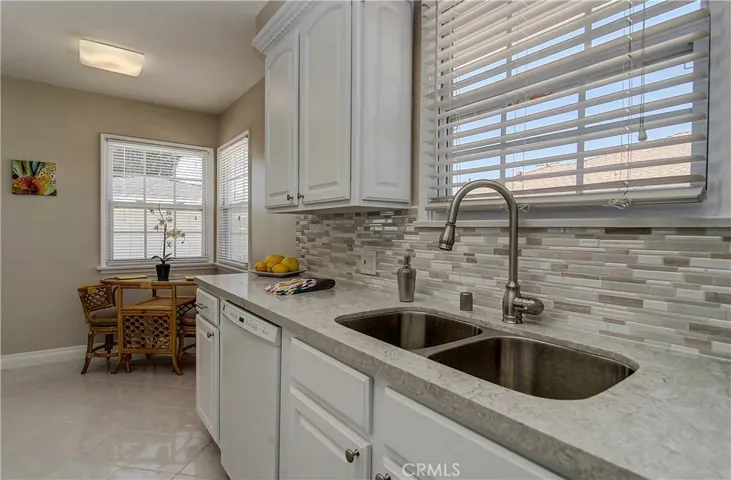 Stunning new Quartz counters, crisp new white paint and custom tile work showcase the cook's dream kitchen.