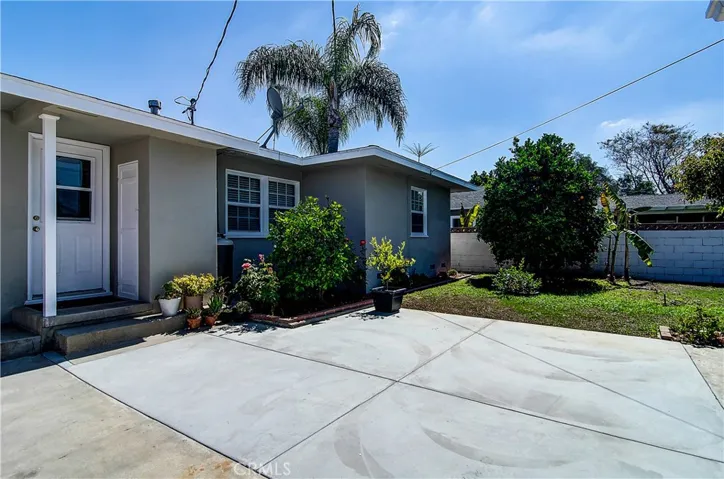 This view shows of the newer concrete patio, crisp exterior paint and newer energy saver windows.