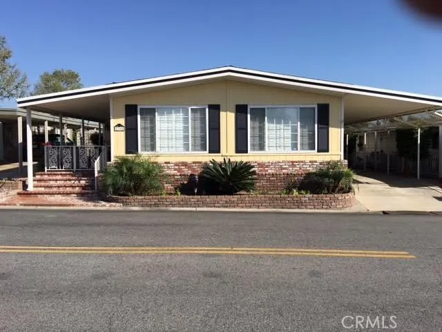 Front View:  Gated porch to your left and carport on the right side
