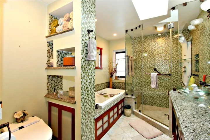 Master bath with separate shower (Hans Grohe shower system) large Whirlpool tub, Toto toilet (Neorest 500) Radiant heat floor, German made medicine cabinets, Italian glass wall.