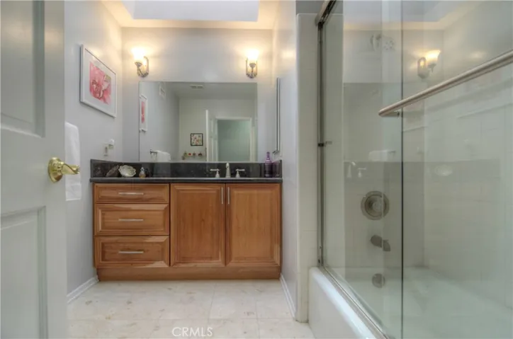 Travertine Floors and Granite Counters, plus the Skylight add add a LUXE FEEL in the hall bath.