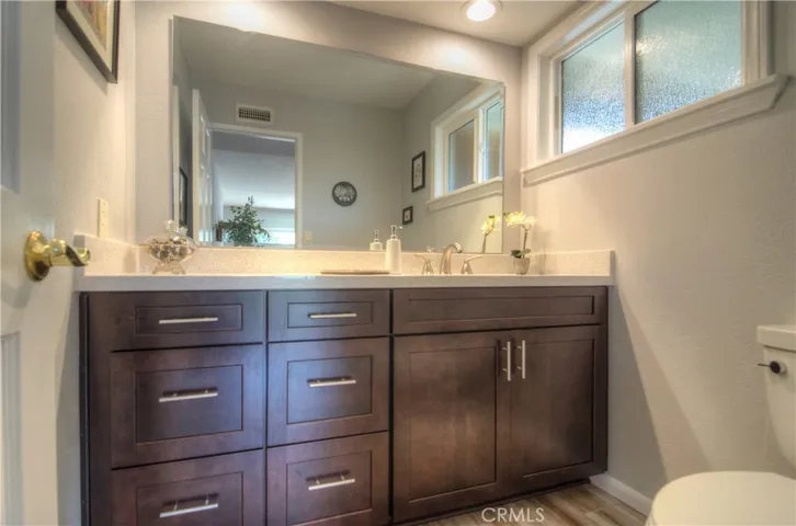 Rich wood cabinetry and solid counters in this sparkling hall bath.