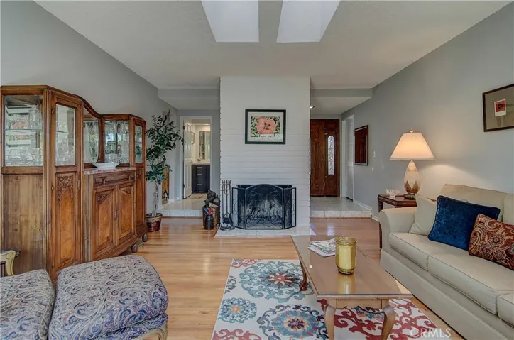 So many great features here...raised foyer with double entry doors, cozy fireplace, skylights, hardwood floors...the list goes on!