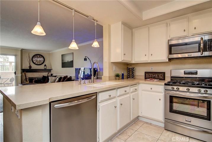 QUARTZ COUNTERS, RECESSSED LIGHTING AND STAINLESS STEEL strike a contemporay note in the Kitchen.