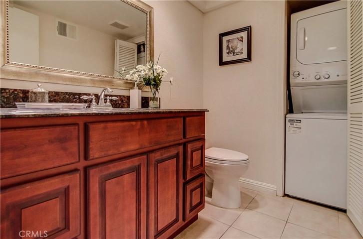 Downstairs Half Bath is Gracious for Guests & Practical for the homeowners with Laundry close by.
