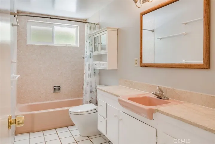 Full hall bathroom with dual-flush, low-flow toilet.
