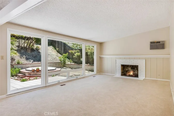 New carpet and paint throughout, the living room with large picture windows essentially brings the outdoors in for hosting indoor/outdoor parties.