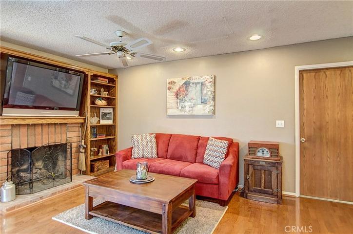 The family room boasts  fireplace and floor to ceiling bookshelves.
