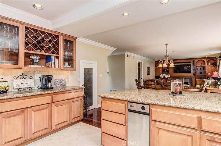 Built-in buffet area offers display cabinets and plenty of wine storage...note walk-in pantry with glass door.