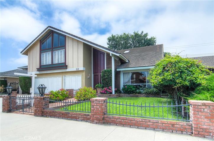 Stately curb appeal with brick accents and mature landscape.