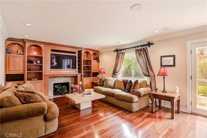 Family rooms don't get better than this...fireplace, custom cabinetry and big screen TV with surround sound.