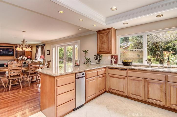The cook is always part of the action here!  Check out the molding and lighting details, plus beautiful views to back yard.