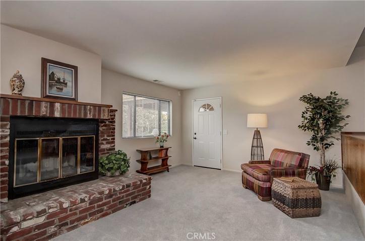 Huge  Family Room with Traditional Brick Fireplace and Raised Hearth.