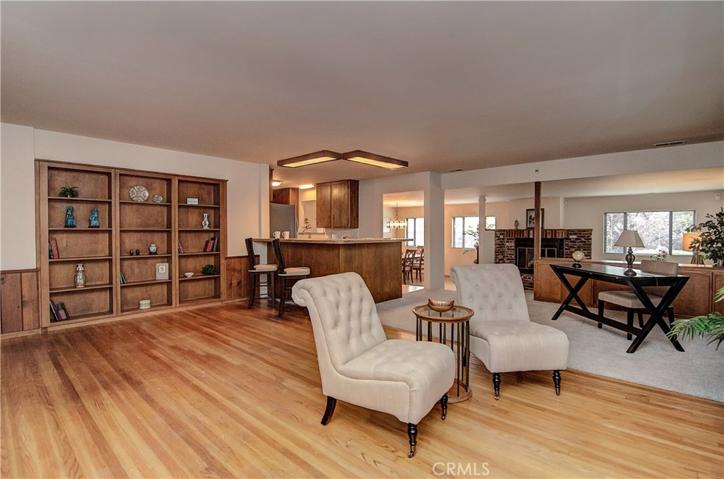 Next, note the Formal Living Room boasts Gorgeous Built-in Bookcases and Hardwood Floors.