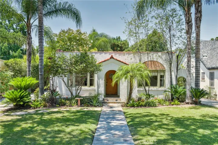 1935 Spanish Eclectic Architecture and a welcoming front walk.