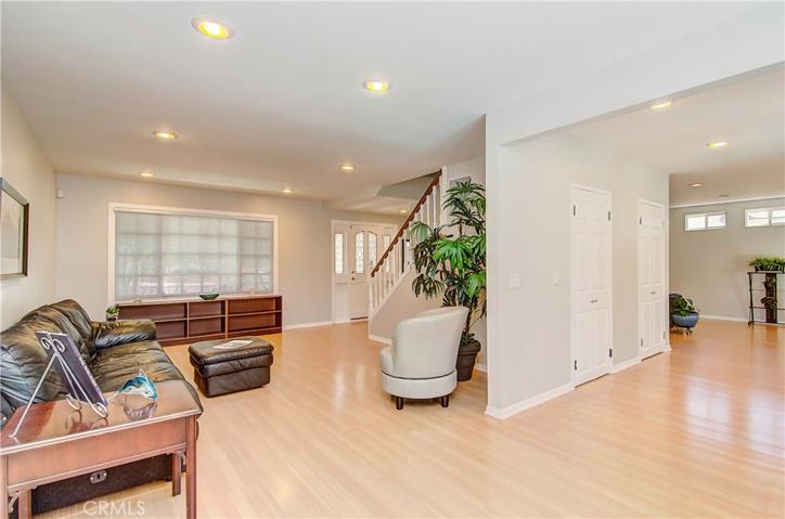 Recessed lighting and laminate wood flooring throughout.