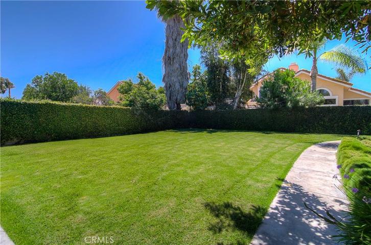 Walking paths all around the backyard and trees growing in areas to enhance privacy.