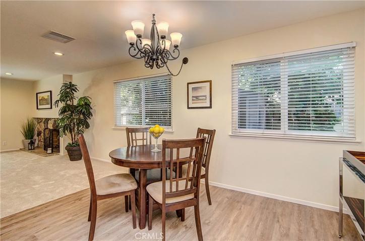 Spacious dining area is open to both the living room and kitchen.  Lovely wood grain plank flooring too!