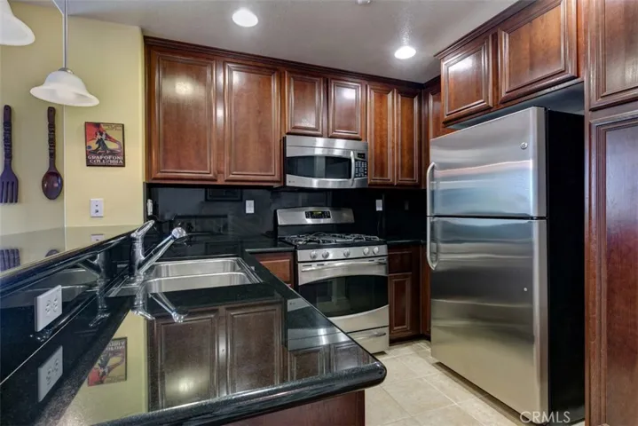 Kitchen features granite counters, back splash and ample plug in for counter top appliances