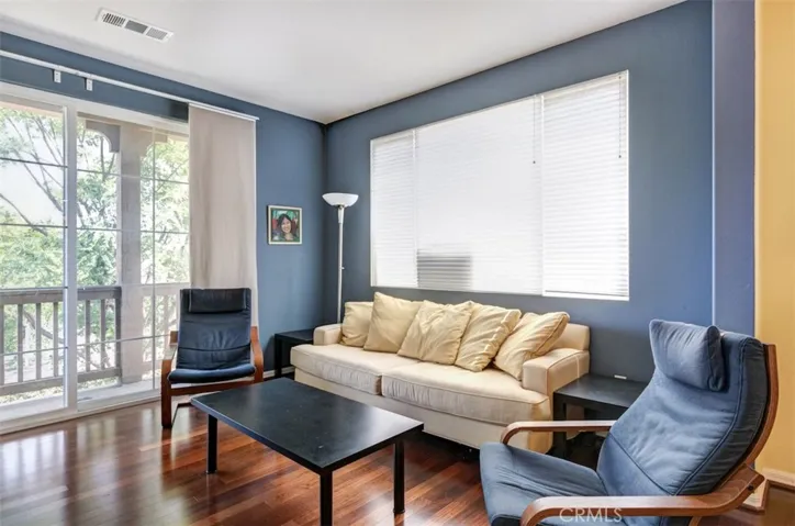Sliding door access to living room balcony and large side window afforded by end unit location