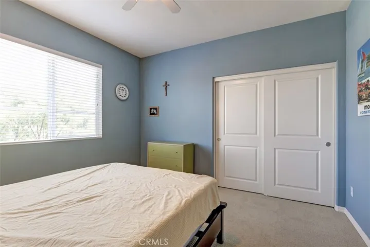 Master bedroom with ceiling fan, upgraded carpet and twin door wardrobe