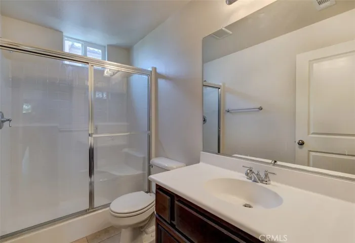 Shared bathroom with large enclosed shower