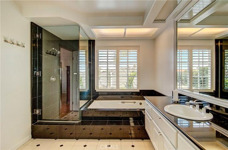Huge glass shower and deep soaking tub in master bath.
