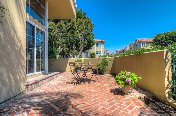 Classic brick terrace is perfect for lounging or outdoor entertaining...elevated location from street adds to privacy.