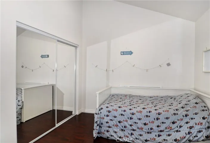 From this Angle you see the Large Closet, Cathedral Ceiling, Bed, Wood Laminate Flooring, and there is space available for more furniture in this spacious Bedroom.