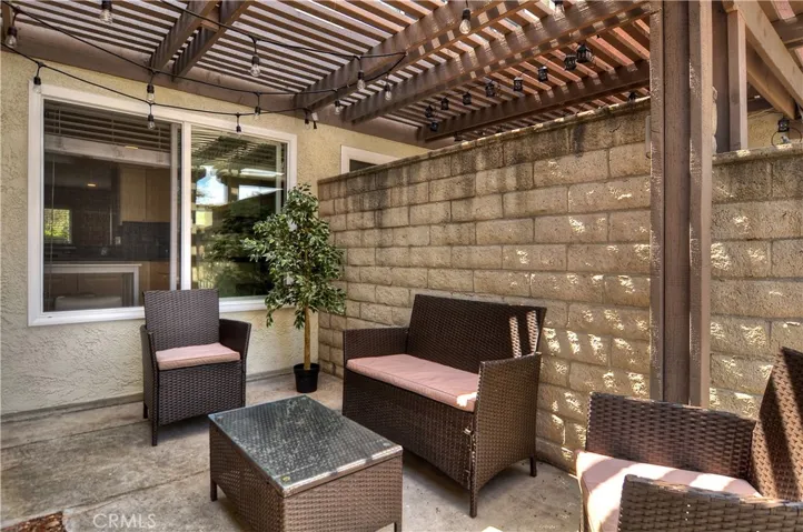 Nice front porch sitting area under the patio covering.