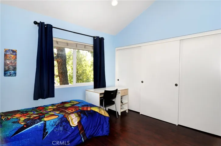 The First spacious Guest Bedroom.  Wood Laminate Flooring, Cathedral Ceilings, Double Pane Windows, and Large Closets.