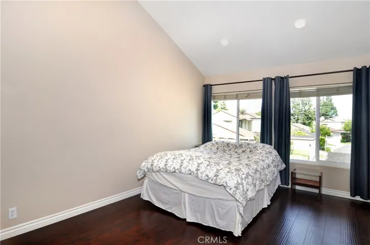Welcome to the very spacious Master Bedroom.  Equipped with Cathedral Ceilings, Recessed Lighting, Double Pane Windows,  Wood Laminate Flooring and as you can see their is plenty of room for more furniture if so desired.