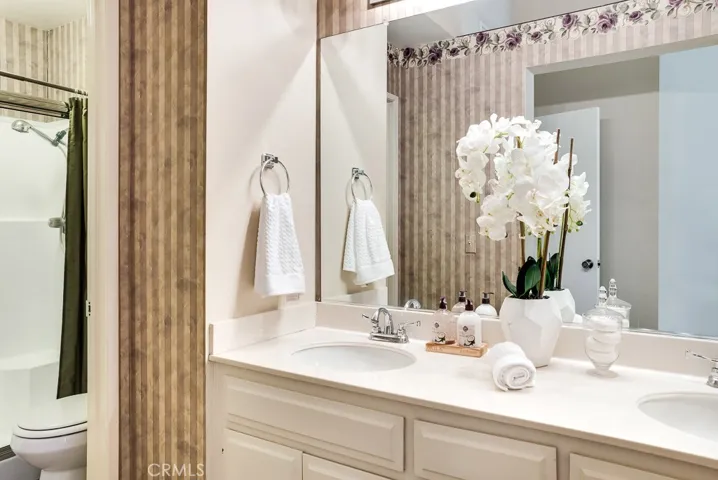 Master Bathroom has dual vanity area separate from shower and commode.