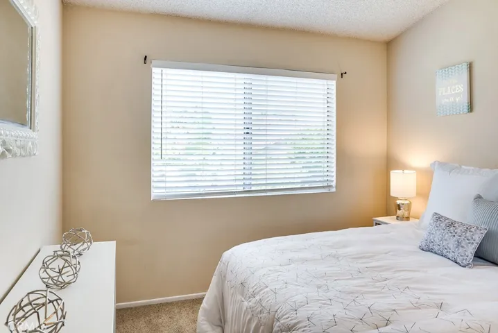 3rd bedroom upstairs with abundance of sunshine through west facing window that overlooks the patio.