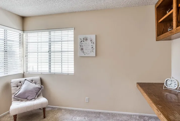 3rd Bedroom upstairs used as office and has built in shelf desk and display or book shelves, or can be used as a TV room, or can easily be converted back to a closet for bedroom.  Not visible but 3rd bedroom also has lighted ceiling fan.