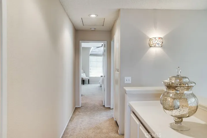 2 separate and individual linen storage areas in upstairs hallway.  The cabinet in the foreground with counter top and additional wall cabinetry between the stairs and bedroom.