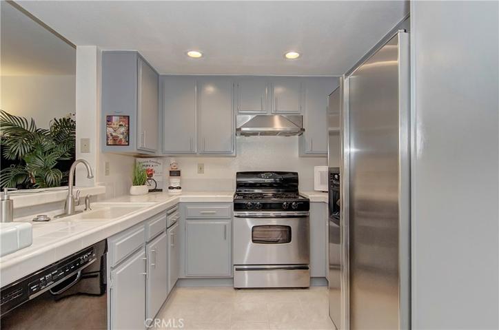 Sparkling kitchen has plenty of prep and cabinet space...lovely contemporary colors too.
