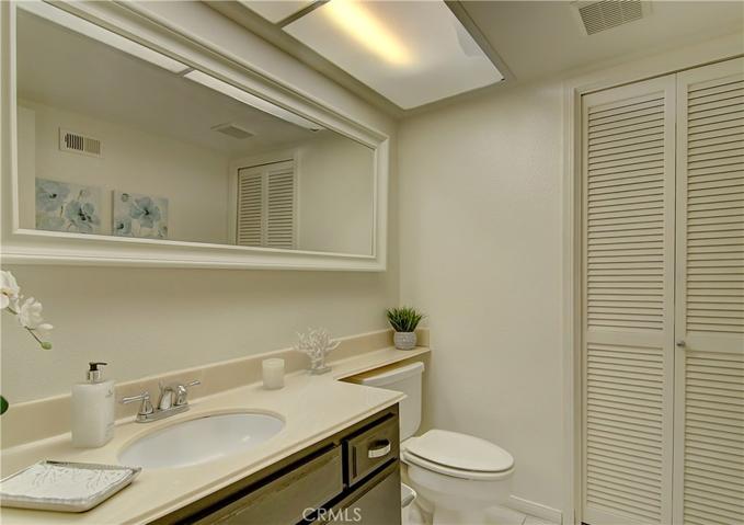 Spacious downstairs guest bath...convenient laundry area behind louvered doors too.
