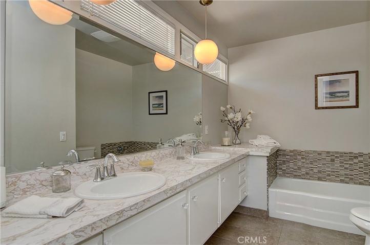 Newly remodeled bathroom with dual vanity, and beautiful tile-work.