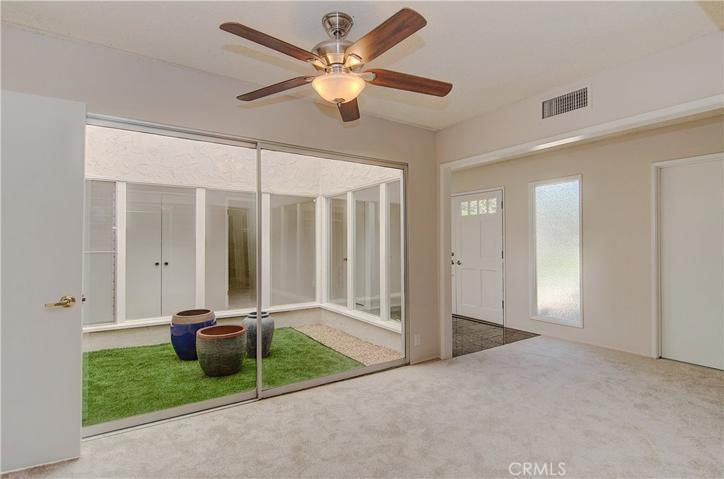 What a cool enclosed atrium. Use it as another patio, focal point, or pet run.