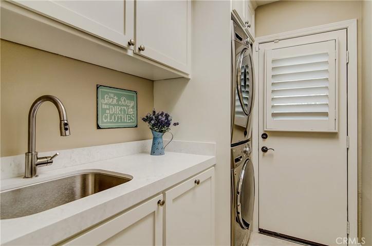 Main floor laundry room with tons of storage and big soaking sink.