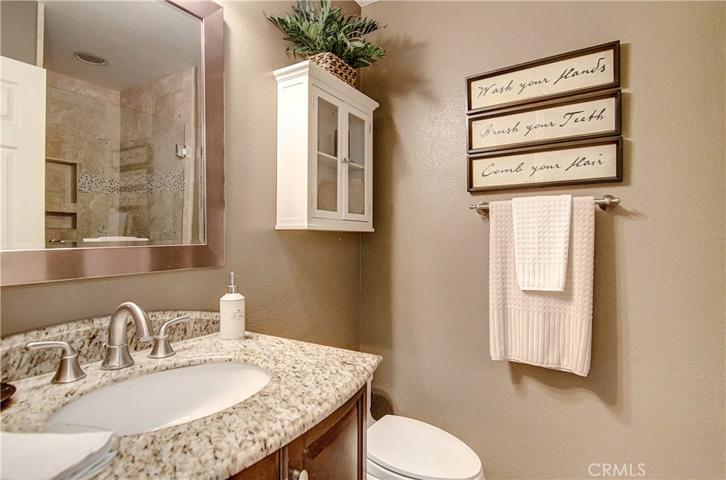 Beautiful downstairs guest bath with brushed nickel and stone accents.